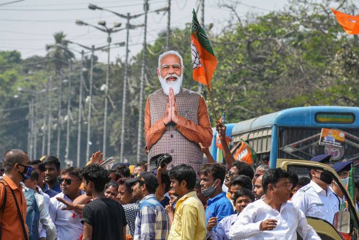 Supporters of Modi’s ruling BJP party carry a cut-out of the prime minister at a campaign rally in March