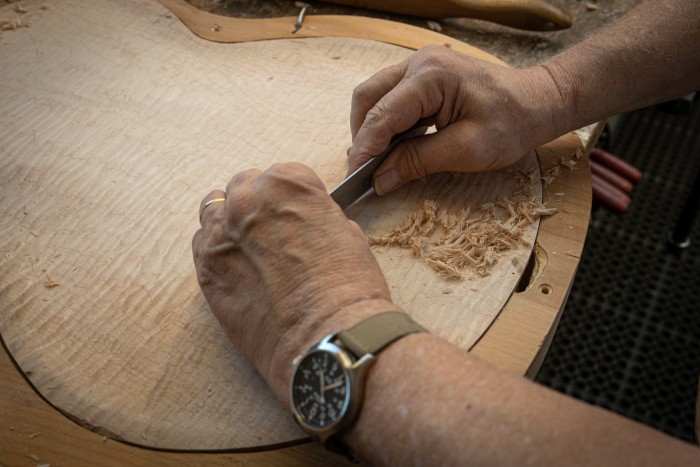 Shaving a piece of tone wood to bring out its resonance