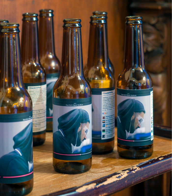 Close-up of brown beer bottles whose labels have a man’s head on
