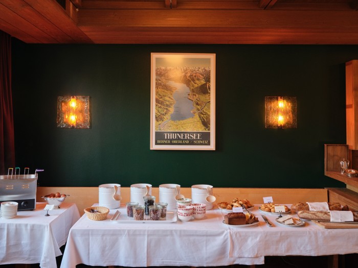 Toni Zuccheri wall lamps flank a c1950 Swiss travel poster in the breakfast room