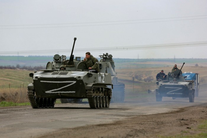 Russian military vehicles move on a highway in an area controlled by Russian-backed separatist forces near Mariupol, Ukraine