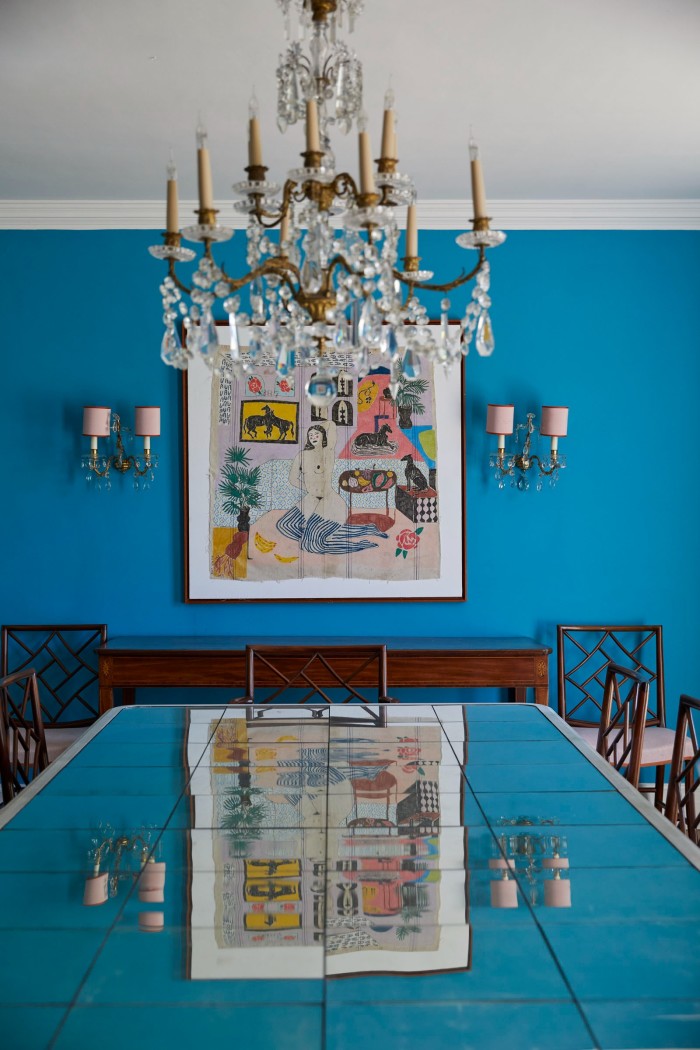 A bespoke dining-room table and chairs by Jeremy Rothman, with a painting on the wall by Lauren dela Roche
