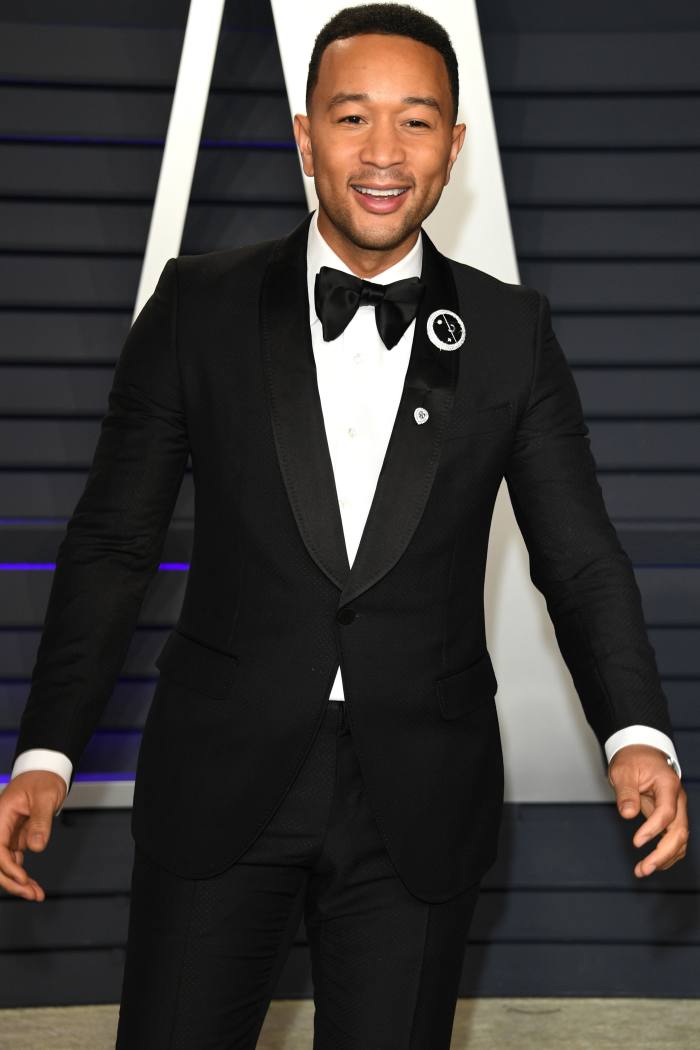 John Legend wears a Dennis Tsui brooch at the 2019 Vanity Fair Oscars party