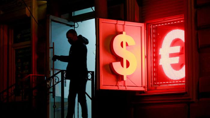 A man walks out of a currency exchange office in Saint Petersburg, Russia