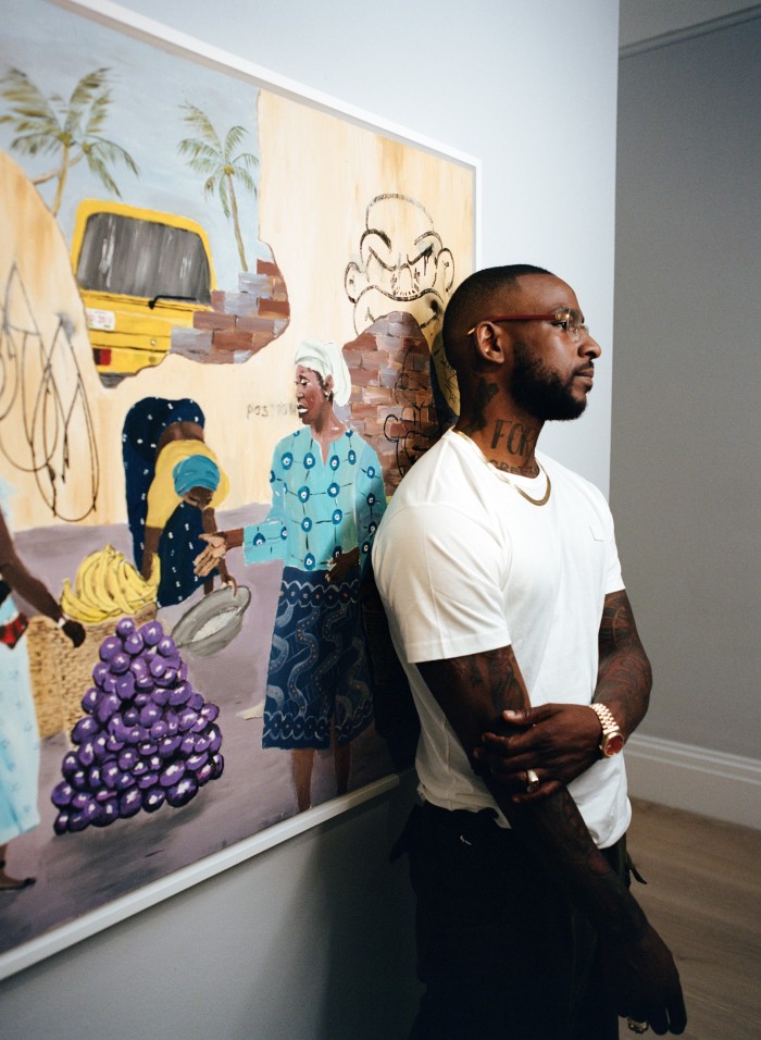 Skepta in front of his painting Mama Goes to Market