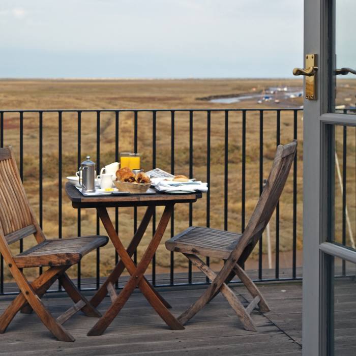 A bedroom with terrace views across the salt marshes