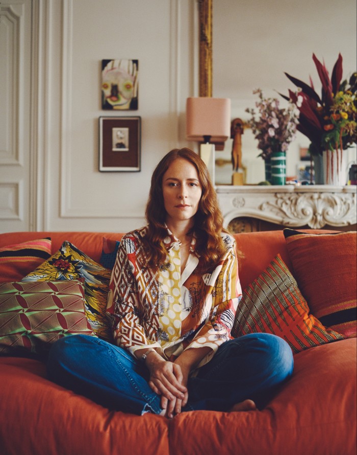 Nadège Vanhée-Cybulski at her Paris home, sitting on one of her George Sherlock sofas