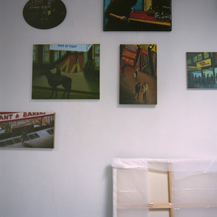 Paintings hanging in the artist’s studio