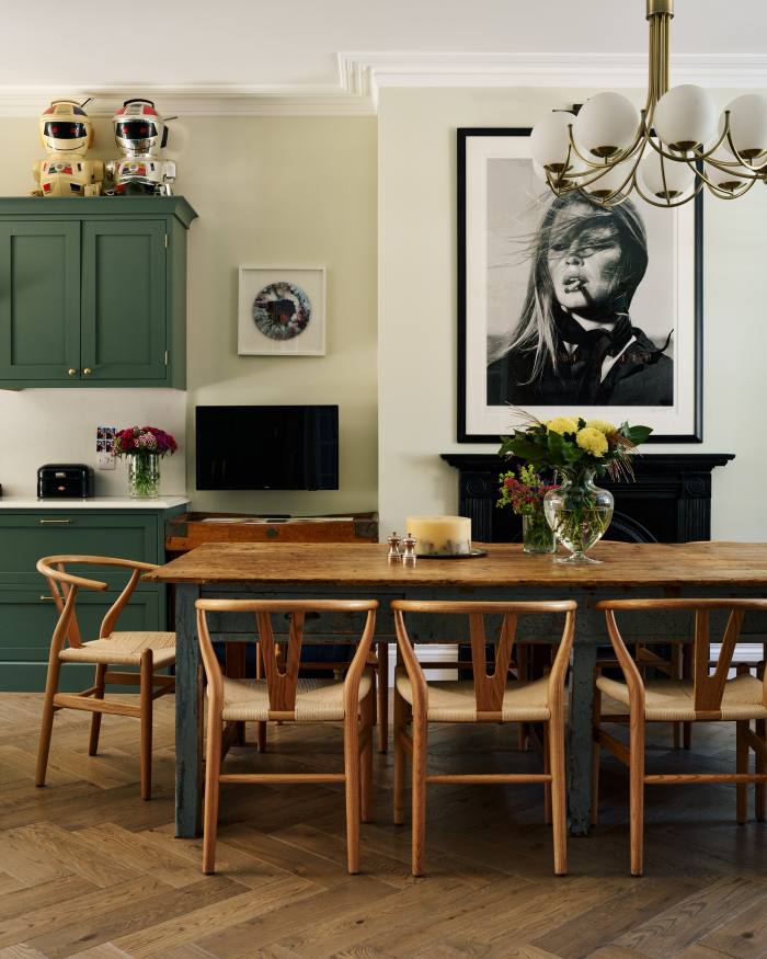 The kitchen table, salvaged from an accountant’s office; an artwork by Alfred Stone and a Brigitte Bardot print by Terry O’Neill hang on the wall 