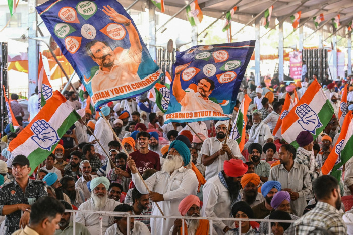 Supporters wave flags with Gandhi’s picture on them