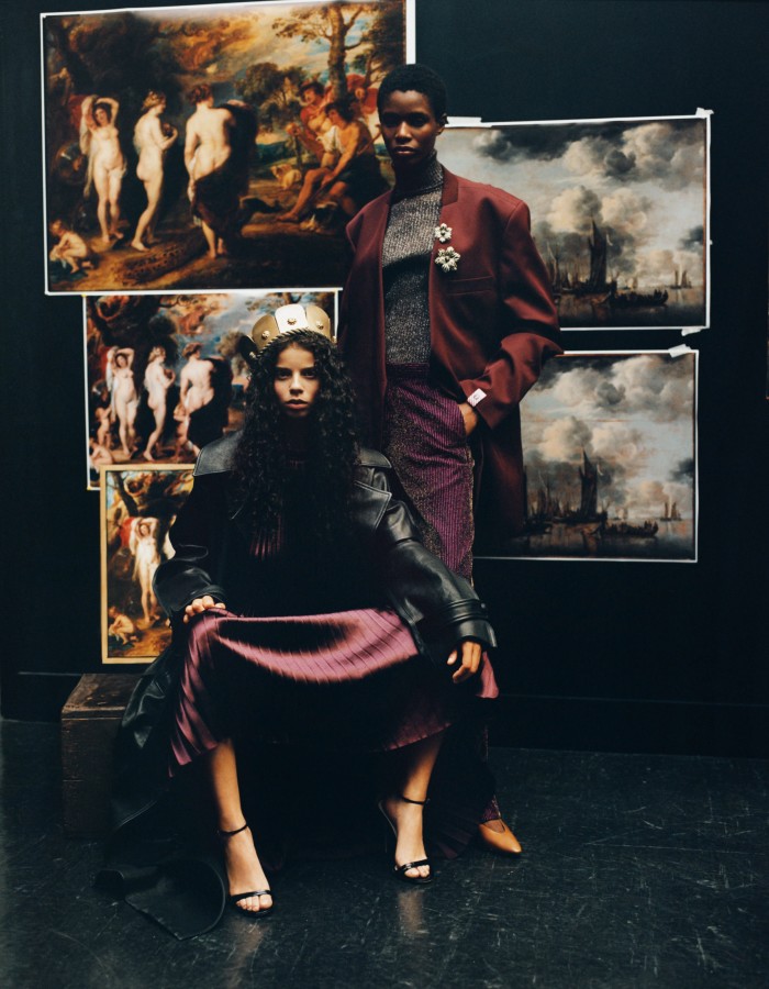 From left: Jordan Whittingham wears Tod’s leather trench, POA. Ulla Johnson satin Amiko dress, £740. Gucci leather sandals, £660. Metal crown, POA, available to rent from Costume Studio. Onyinyechi Chijioke wears Martine Rose wool blazer, POA, cotton-mix military jumper, £878, and cotton-mix trousers, £441. Loro Piana leather Rebecca ballerinas, £620. Chanel metal and resin strass brooches, £2,040 and £1,250