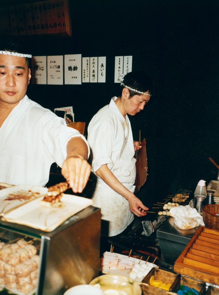 Chefs cook chicken skewers at Toriyoshi Ginza, Tokyo
