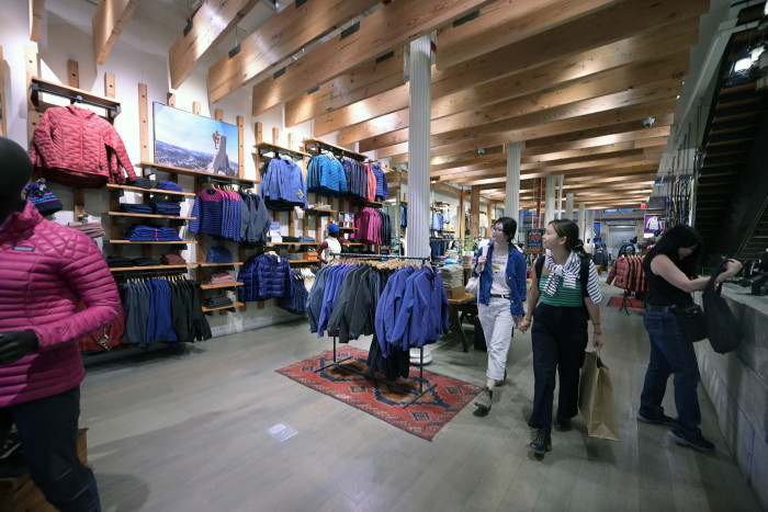 Down and fleece jackets and other merchandise on display inside Patagonia outdoor apparel retail store