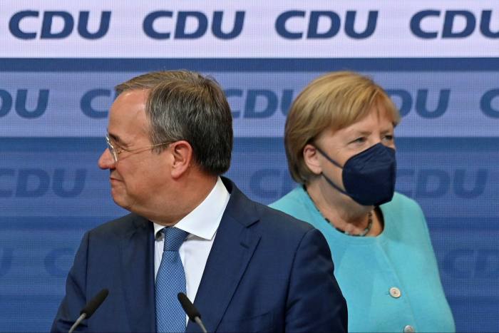 Armin Laschet (left), the CDU’s candidate to become Germany’s chancellor after Angela Merkel (right), strongly defended the country’s existing health system
