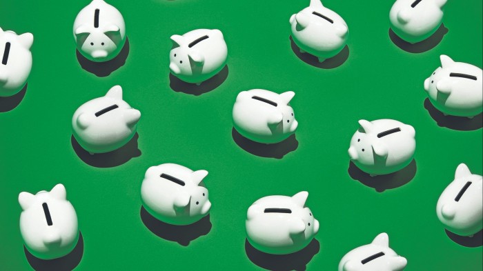 white piggy banks on a green surface