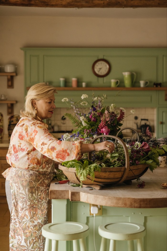 Hibbert arranges flowers in the family kitchen
