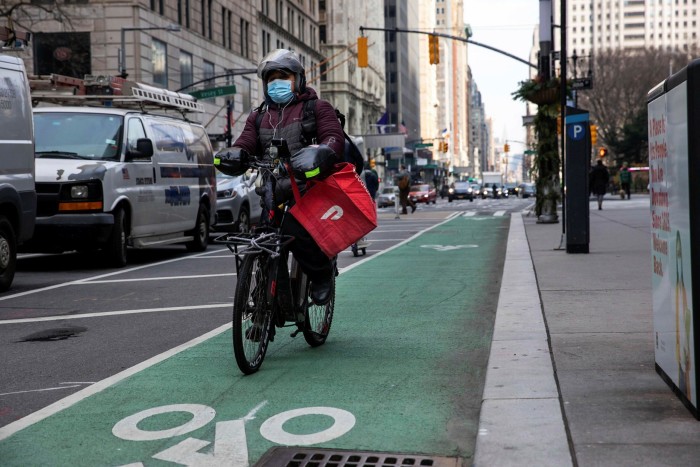 A DoorDash bicycle courier during a delivery in New York