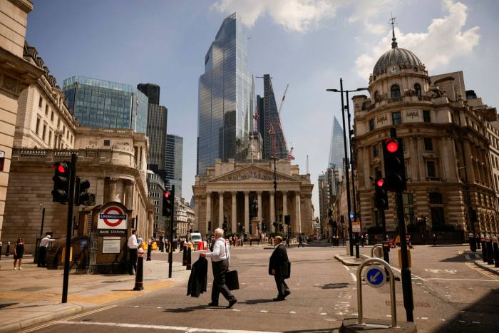 Pedestrians walk near the Bank of England