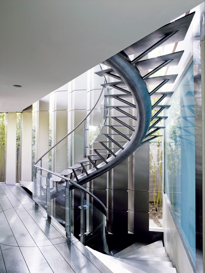 Curves such as a spiral staircase soften the linear profiles at Crescent House