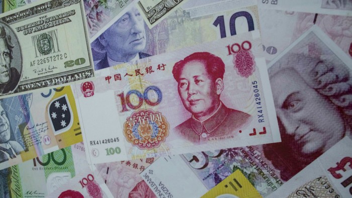 A renminbi note on top of other foreign currencies