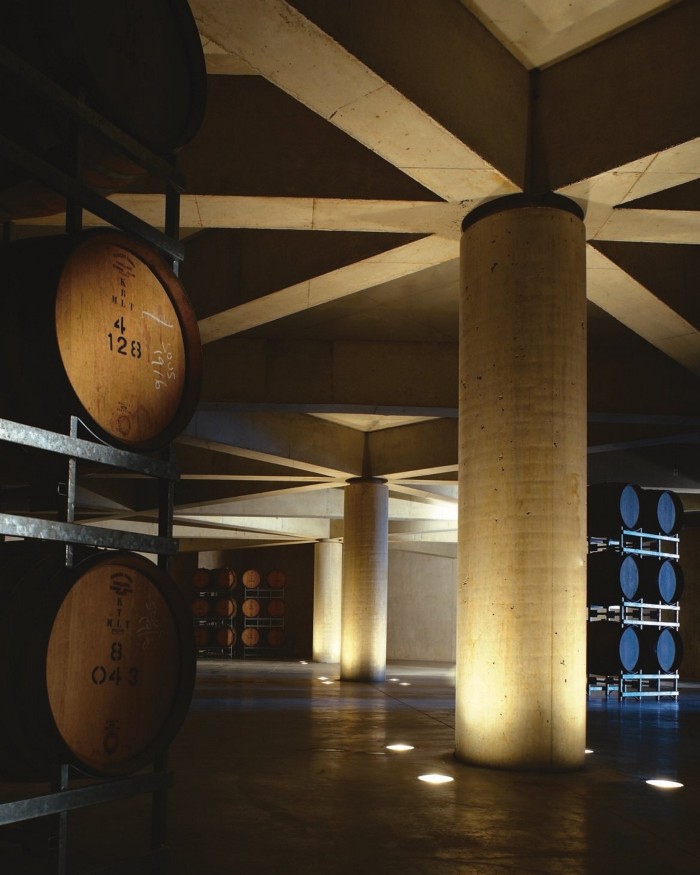 Large wooden vats in the dimly lit barrel room at Port Phillip Estate 