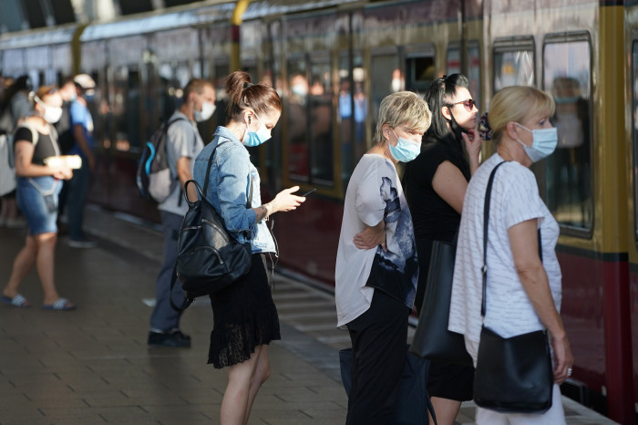 Commuters wearing protective face masks