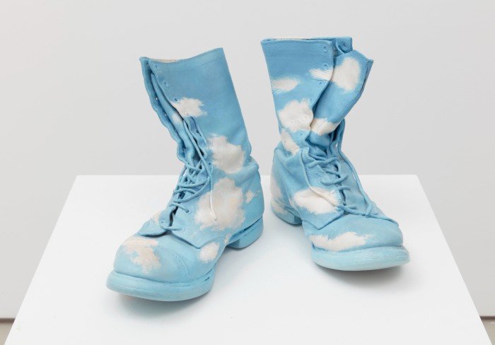 A pair of boots painted like a bright sky with white clouds