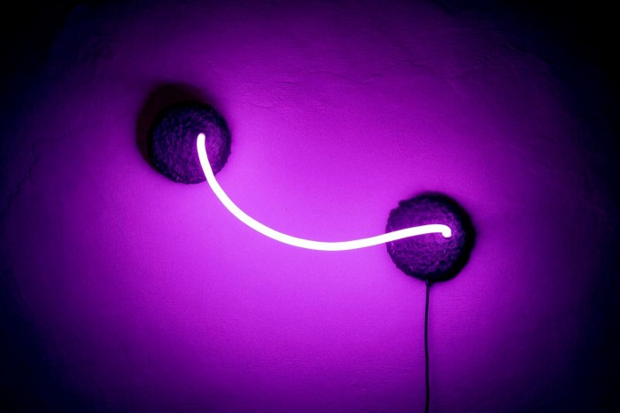 A short neon strip casts a purple light