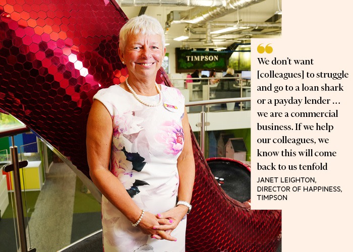 An image of a smiling Janet Leighton, who is the director of Happiness at Timpson, with a quote saying “We don’t want [colleagues] to struggle and go to a loan shark or a payday lender . . . we are a commercial business. If we help our colleagues, we know this will come back to us tenfold.”