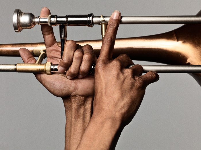 Andrews’s hands on a trombone