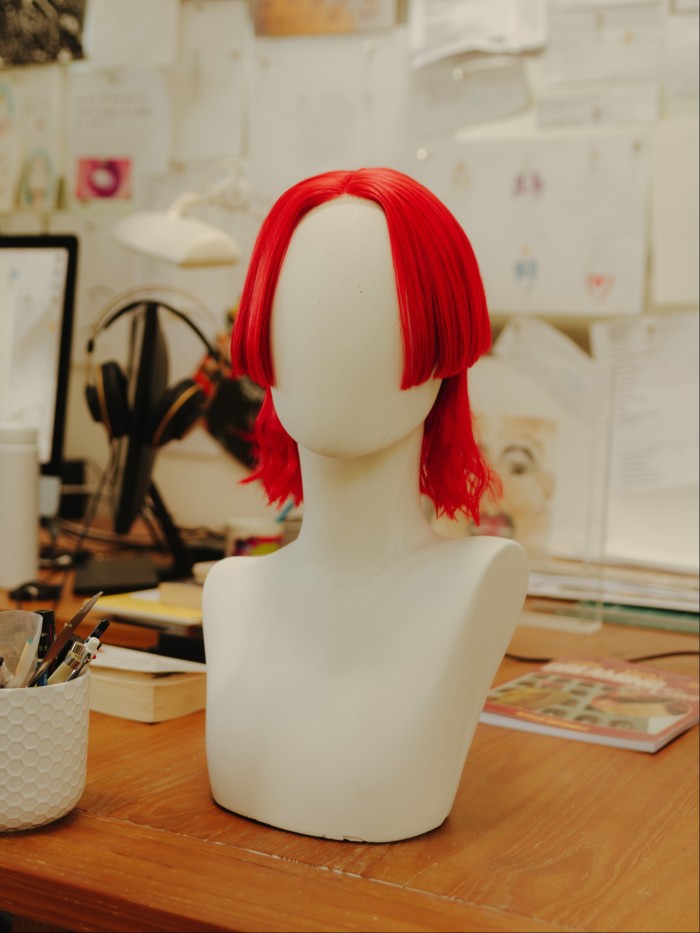 A red wig on a mannequin bust