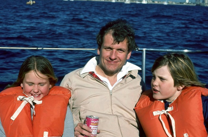 With her brother and father on the family boat, Iona, in 1977