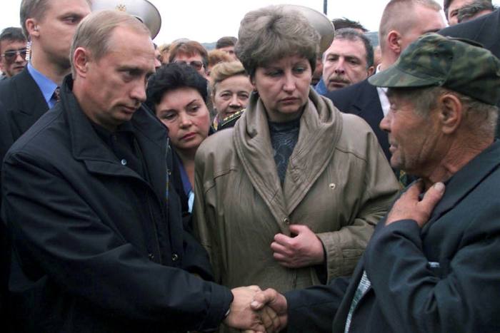 Vladimir Putin shakes hands with a relative of a crew member of the sunken submarine Kursk in August 2000