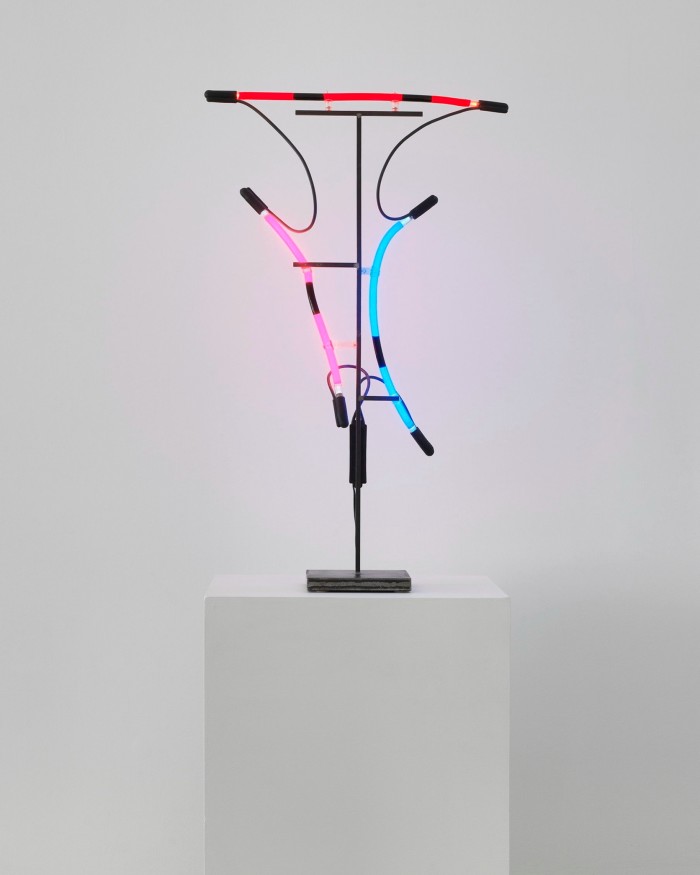 Two works with short bendy neon tubes of various colours held up on a stand