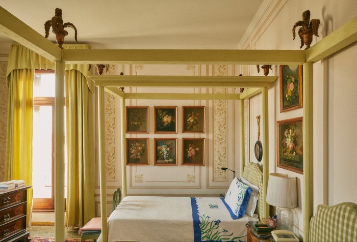 The twin beds in the main guest room, which overlooks the Grand Canal, with flower paintings added by Cristiana