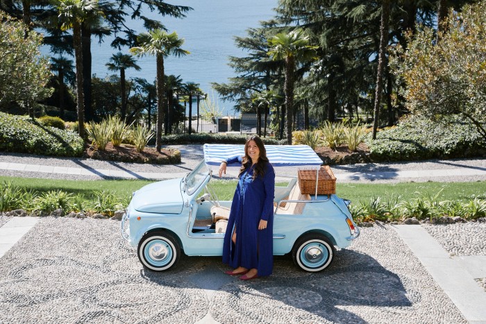 Valentina De Santis beside the electric vintage convertible Fiat 500 that takes guests between the villa’s terraces
