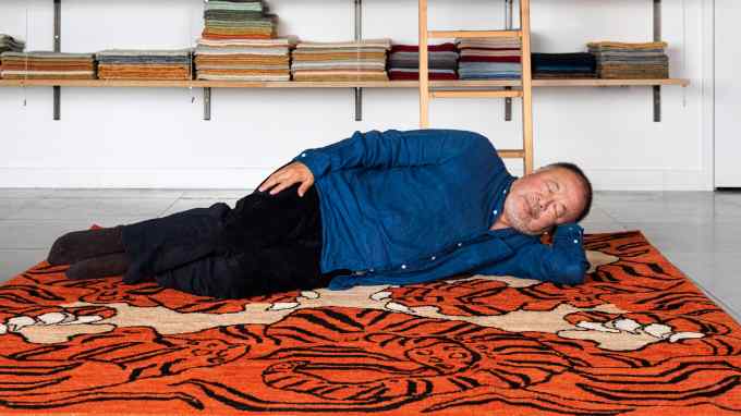 Ai Weiwei with his rug The Tyger, made by Christopher Farr
