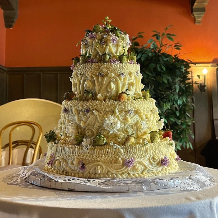 Aimee France’s cake for Chloë Sevigny’s wedding: an Earl Grey cake layered with ricotta, market strawberries and homemade passion fruit curd, with a brown butter ginger buttercream exterior, decorated with sweet alyssum, lilac and strawberries