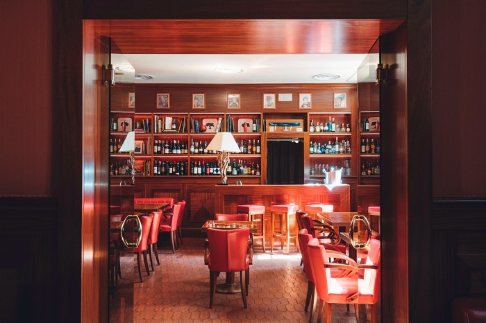Rose-wood walls, red-leather seating and shelves filled with bottles of wine and spirits in Dal Bolognese’s members’-club-style dining space