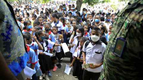 Schoolchildren queue for Covid vaccines in East Timor. The pandemic has exposed our current economic model as insufficient, outmoded and negligent