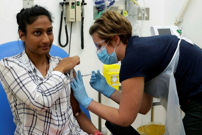 A volunteer is injected during coronavirus vaccine trials led by Oxford university. Drugmaker AstraZeneca signed a deal with the university to manufacture up to 100m doses by the end of 2020, prioritising supply in the UK