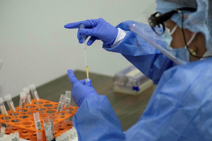 A health worker sorts blood samples for Covid-19 vaccination study for pharmaceuticals company Janssen, of Johnson & Johnson, as part of a phase 3 study in Cali, Colombia