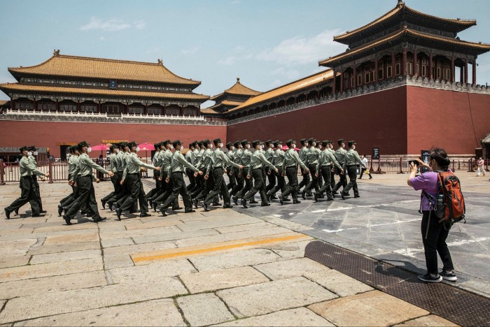 Show of strength: People’s Liberation Army soldiers march past the Forbidden City in Beijing. China’s growing military capacity is stoking unease in Washington