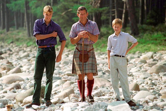 King Charles, then the Prince of Wales, wearing a kilt at Balmoral, alongside his sons
