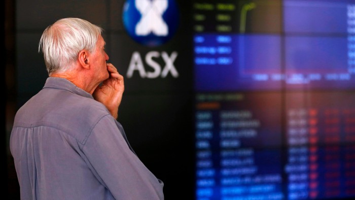 A man looks an electronic board inside the Australian Securities Exchange