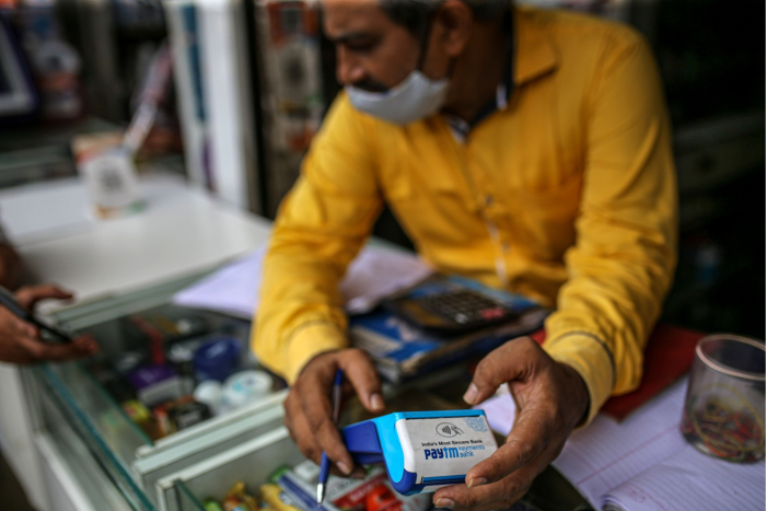 A Mumbai shopkeeper uses a Paytm terminal