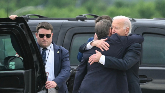 Joe Biden hugs his son Hunter beside a vehicle
