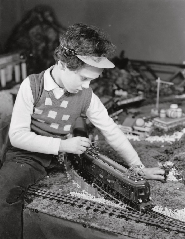 A boy with a train set, c1955