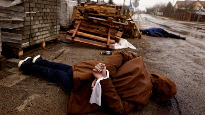 A body with hands bound by white cloth, who according to residents was shot by Russian soldiers, lies on the street in Bucha, Ukraine on April 3