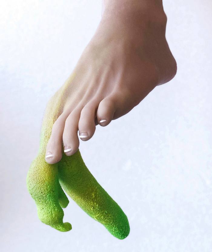 Photo of a person’s foot where the big toe is growing into something phallic and green